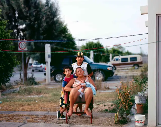 Mother with children in Juarez Suburb by Alejandro Cartagena
