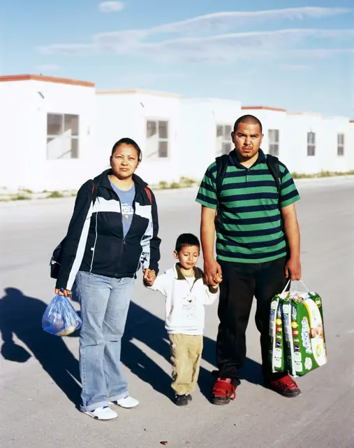 Family walking home to Juarez Suburb by Alejandro Cartagena